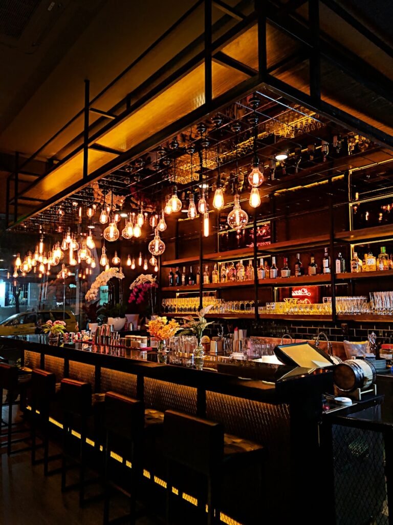Miguel Jimenez Bar en Saro turned-on filament bulb lights at bar counter